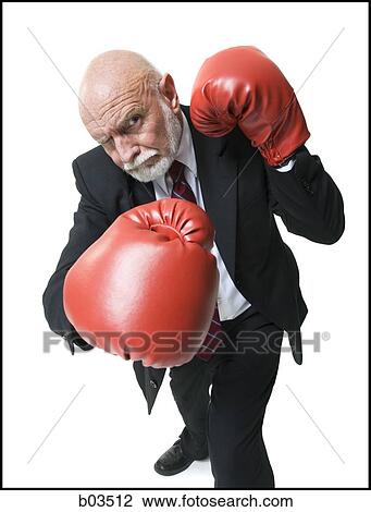 Stock Image - Businessman with boxing gloves. Fotosearch