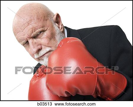 Stock Image - Businessman with boxing gloves. Fotosearch