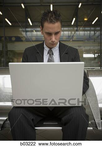Stock Image - Businessman with laptop. Fotosearch