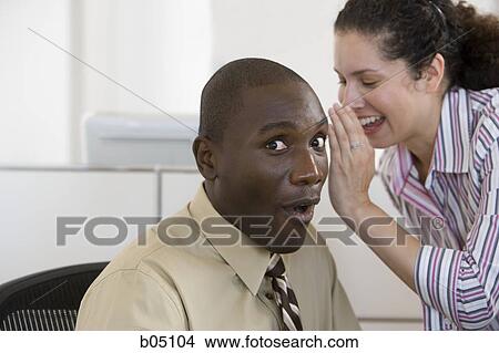Businesswoman whispering to businessman View Large Photo Image Picture - Businesswoman whispering to businessman. Fotosearch