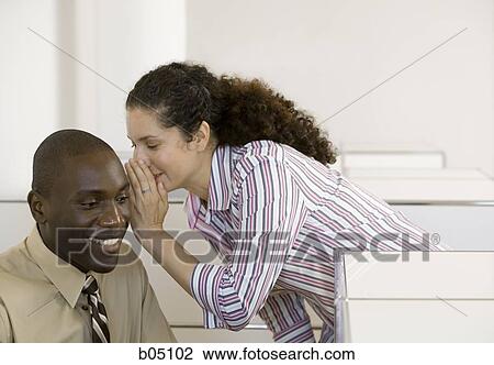 Businesswoman whispering to businessman View Large Photo Image Stock Image - Businesswoman whispering to businessman. Fotosearch
