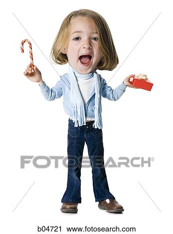 Stock Image - Caricature of girl with candy cane and Christmas gift. Fotosearch