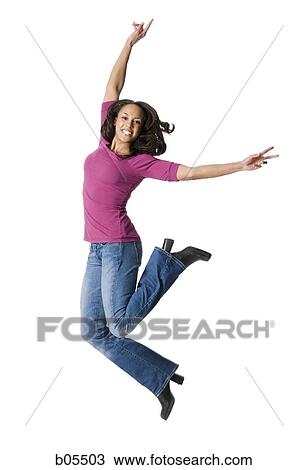 Stock Image - Casually dressed woman jumping. Fotosearch