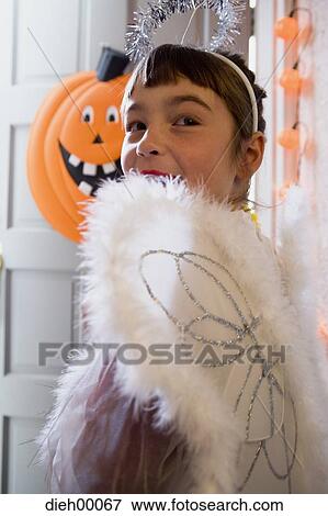 Stock Photo - Child in an angel costume on Halloween. Fotosearch