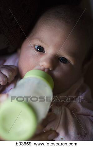 Close up of baby with bottle View Large Photo Image Stock Photo - Close up of baby with bottle. Fotosearch
