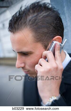 Close up of man on cell phone View Large Photo Image Stock Photo - Close up of man on cell phone. Fotosearch