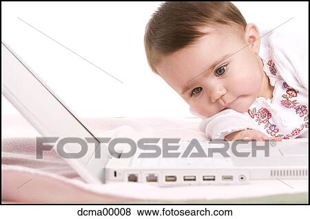 Stock Photo - Closeup of a baby with laptop. Fotosearch