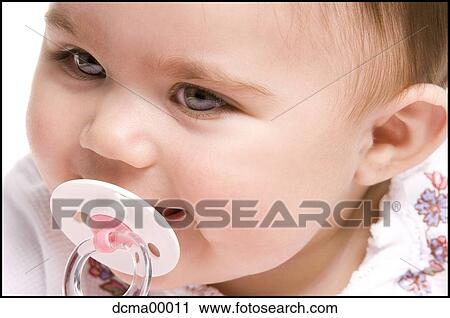 Stock Image - Closeup of a baby with pacifier. Fotosearch