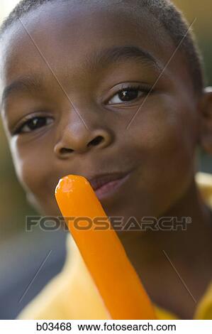 Closeup of boy holding popsicle View Large Photo Image Stock Photo - Closeup of boy holding popsicle. Fotosearch