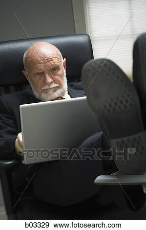 Closeup of businessman in office View Large Photo Image Stock Photo - Closeup of businessman in office. Fotosearch