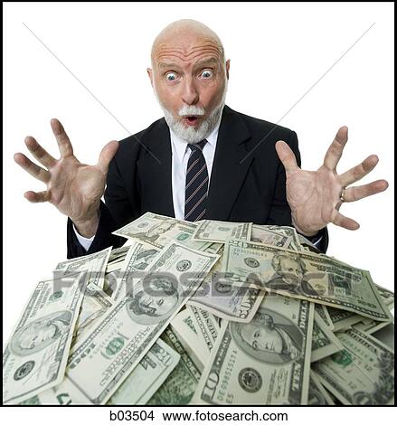 Closeup of businessman looking at pile of money View Large Photo Image Picture - Closeup of businessman looking at pile of money. Fotosearch