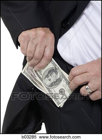 Closeup of businessman putting US banknotes in pocket View Large Photo Image Stock Photography - Closeup of businessman putting US banknotes in pocket. Fotosearch
