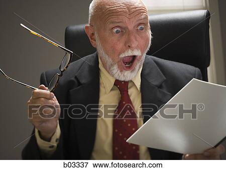 Closeup of businessman reading report View Large Photo Image Stock Photo - Closeup of businessman reading report. Fotosearch