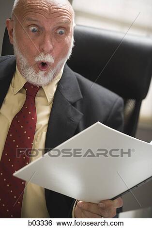 Closeup of businessman reading report View Large Photo Image Stock Photograph - Closeup of businessman reading report. Fotosearch