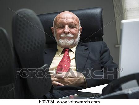 Closeup of businessman sleeping in office View Large Photo Image Picture - Closeup of businessman sleeping in office. Fotosearch