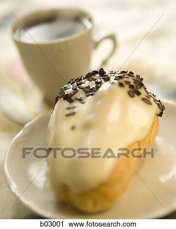 Stock Image - Closeup of coffee and donut. Fotosearch