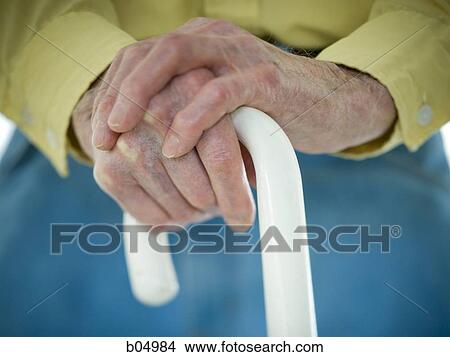 Closeup of elderly male hands on white cane View Large Photo Image Picture - Closeup of elderly male hands on white cane. Fotosearch