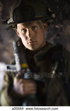 Picture - Closeup of fire fighter at work. Fotosearch