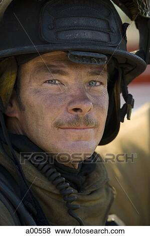 Stock Photo - Closeup of fire fighter at work. Fotosearch