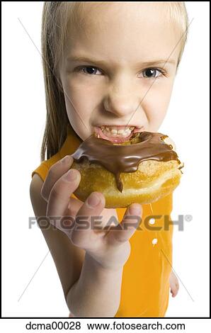 Stock Photo - Closeup of girl eating donut. Fotosearch
