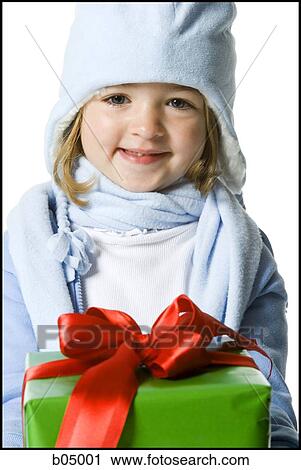 Closeup of girl giving Christmas gift View Large Photo Image Stock Image - Closeup of girl giving Christmas gift. Fotosearch