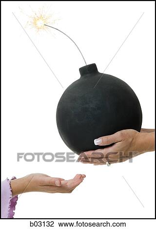 Stock Image - Closeup of hands with bomb. Fotosearch