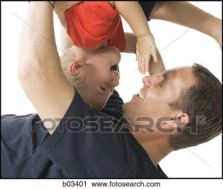 Closeup of man holding boy upside down View Large Photo Image Stock Image - Closeup of man holding boy upside down. Fotosearch