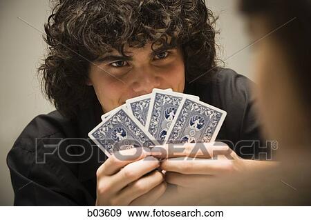 Stock Photo - Closeup of man playing cards. Fotosearch