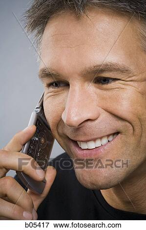 Closeup of man talking on cell phone View Large Photo Image Stock Photo - Closeup of man talking on cell phone. Fotosearch