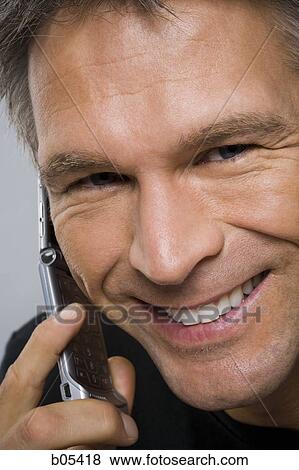Stock Photo - Closeup of man talking on cell phone. Fotosearch
