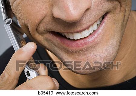 Stock Photo - Closeup of man talking on cell phone. Fotosearch