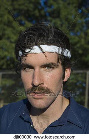 Stock Image - Closeup of man wearing headband. Fotosearch