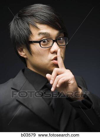 Closeup of man with finger to mouth saying shhhh View Large Photo Image Stock Photo - Closeup of man with finger to mouth saying shhhh. Fotosearch