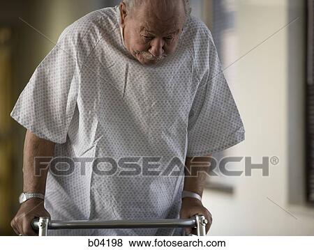 Closeup of mature man in hospital gown with walker View Large Photo Image Stock Photo - Closeup of mature man in hospital gown with walker. Fotosearch