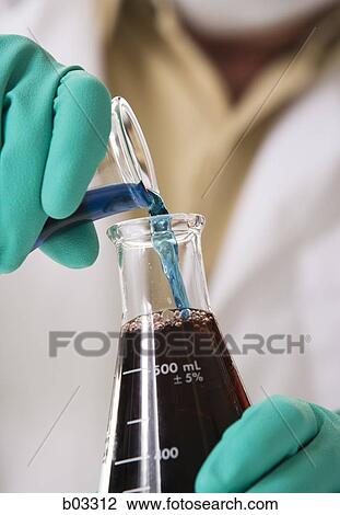 Closeup of scientist pouring chemicals into beaker View Large Photo Image Stock Image - Closeup of scientist pouring chemicals into beaker. Fotosearch