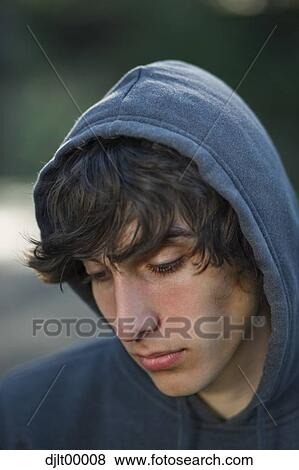 Closeup of teenage boy wearing hoodie View Large Photo Image Stock Photo - Closeup of teenage boy wearing hoodie. Fotosearch