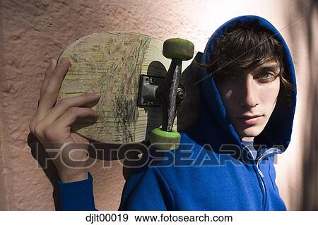 Closeup of teenager with skateboard View Large Photo Image Stock Photo - Closeup of teenager with skateboard. Fotosearch