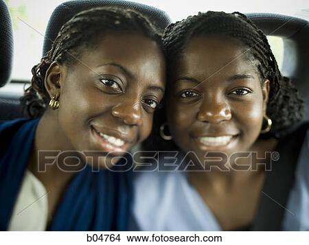 Picture - Closeup of two women smiling. Fotosearch