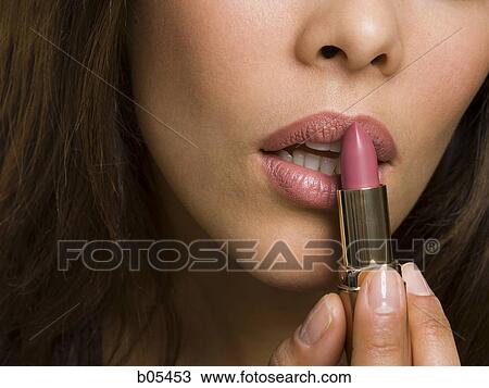 Closeup of woman applying lipstick View Large Photo Image Stock Image - Closeup of woman applying lipstick. Fotosearch