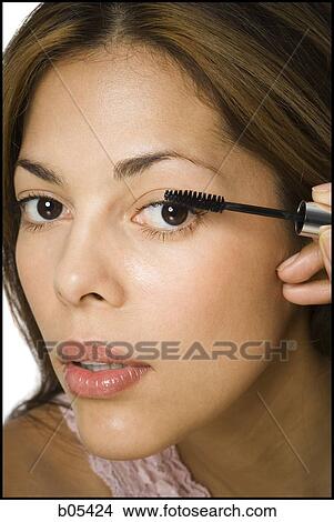 Closeup of woman applying mascara View Large Photo Image Picture - Closeup of woman applying mascara. Fotosearch