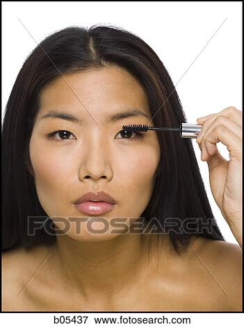 Stock Photo - Closeup of woman applying mascara. Fotosearch