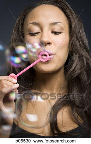 Closeup of woman blowing bubbles View Large Photo Image Stock Image - Closeup of woman blowing bubbles. Fotosearch