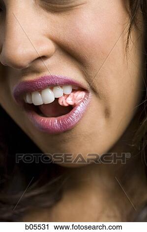 Stock Image - Closeup of woman chewing gum. Fotosearch