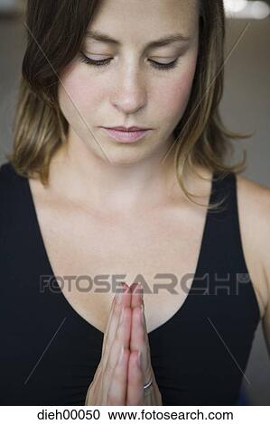 Stock Image - Closeup of woman doing yoga. Fotosearch