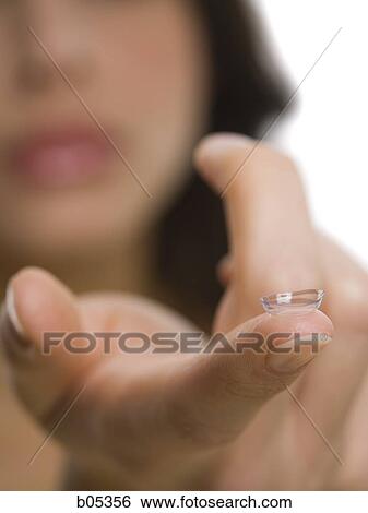 Closeup of woman holding contact lens View Large Photo Image Stock Photograph - Closeup of woman holding contact lens. Fotosearch