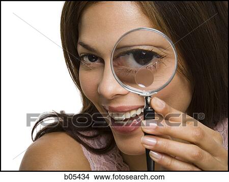 Closeup of woman looking through magnifying glass View Large Photo Image Picture - Closeup of woman looking through magnifying glass. Fotosearch