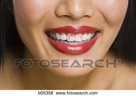 Closeup of woman smiling with red lipstick on teeth View Large Photo Image Stock Photo - Closeup of woman smiling with red lipstick on teeth. Fotosearch