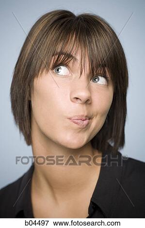 Closeup of woman with green eyes deciding View Large Photo Image Stock Photo - Closeup of woman with green eyes deciding. Fotosearch