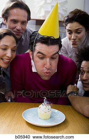 Co-workers around a birthday cupcake View Large Photo Image Stock Image - Co-workers around a birthday cupcake. Fotosearch