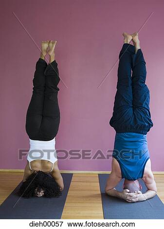 Couple doing headstands rear view View Large Photo Image Stock Photo - Couple doing headstands rear view. Fotosearch